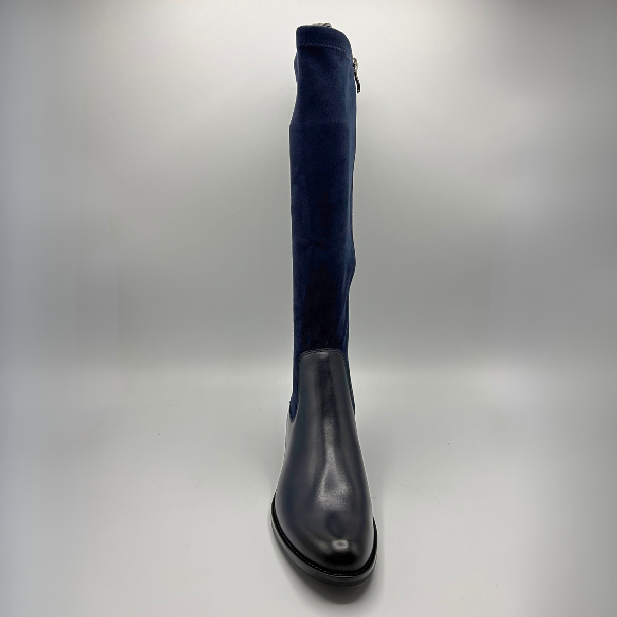 Front view of a tall navy boot with an inner zipper closure