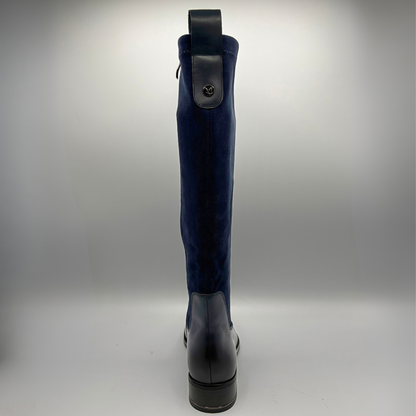 Back view of a tall navy boot with an inner zipper closure