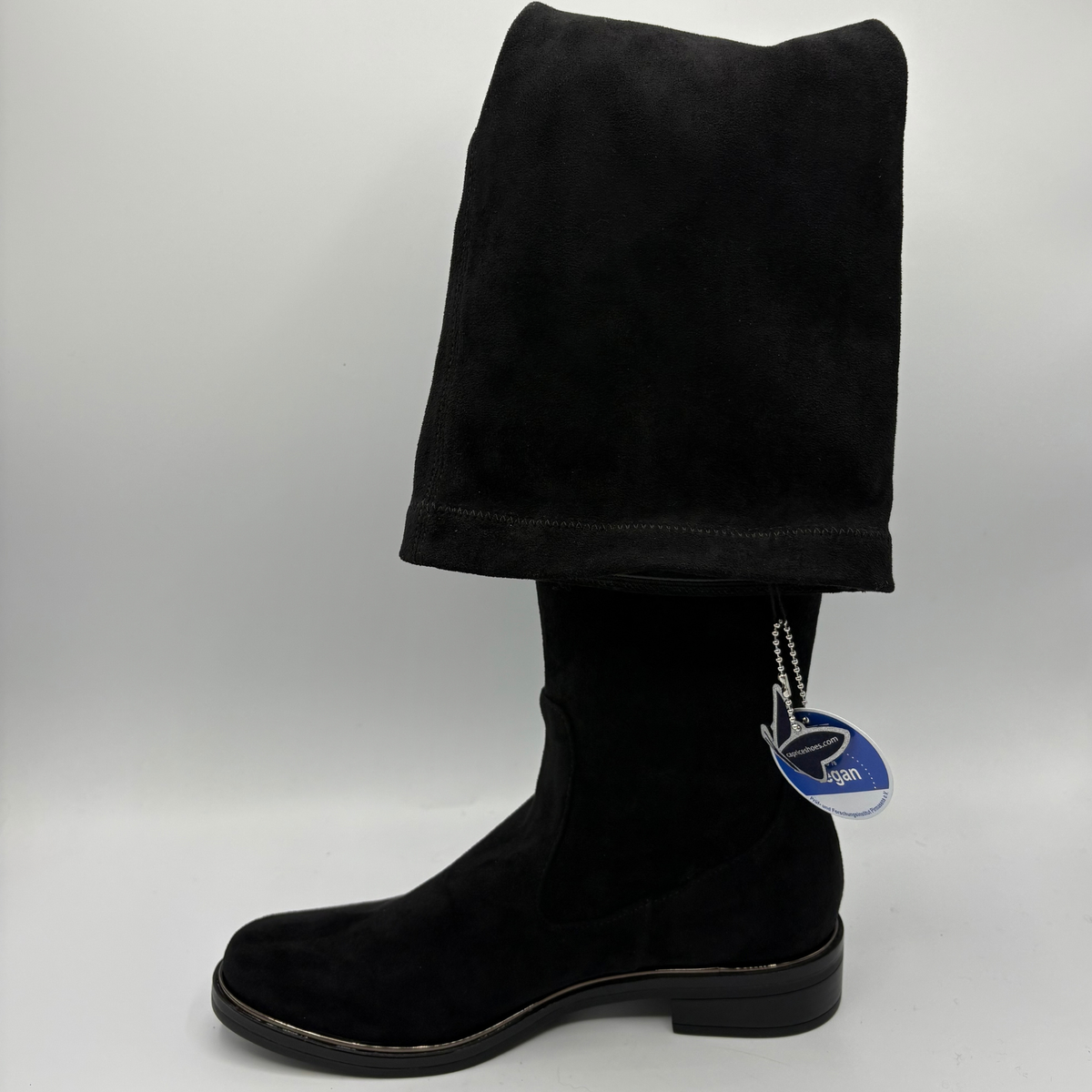 Left facing view of a tall black boot on a white background