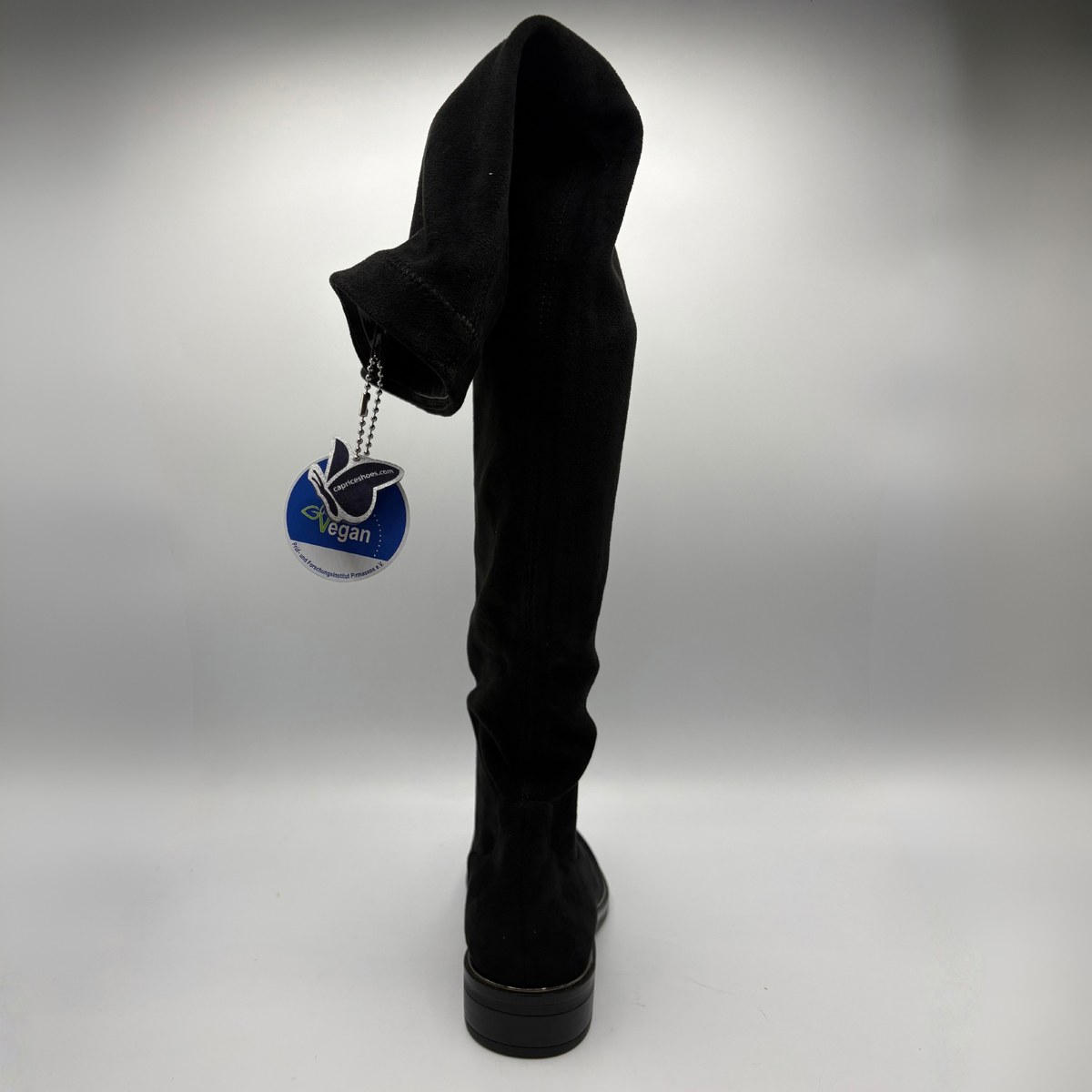 Back view of a black tall boot on a white background