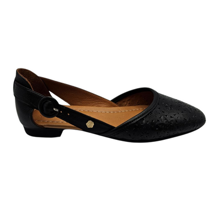 Right facing view of a black perforated leather flat with a slightly pointed toe. Leather lined and has an adjustable side strap.