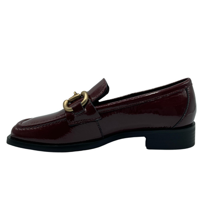 Left facing view of burgundy leather loafer with gold bit detail on upper