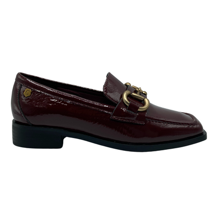 Right facing view of burgundy loafer with black outsole with gold bit detail on upper