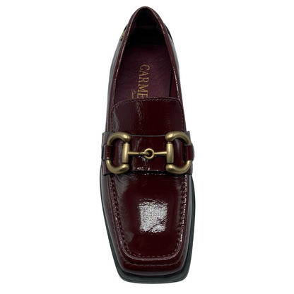 Top view of burgundy leather loafer with square toe and gold bit detail on upper