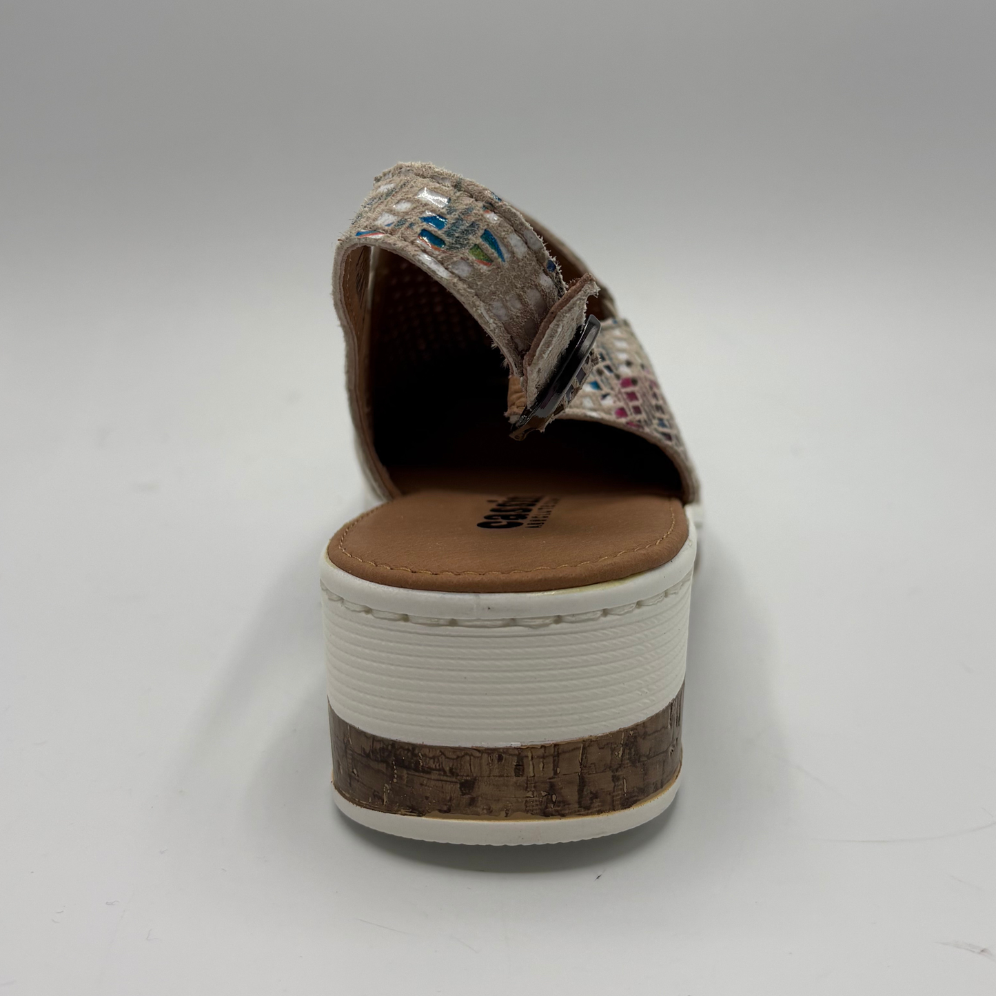 Brown shoe with cork sole on a white background