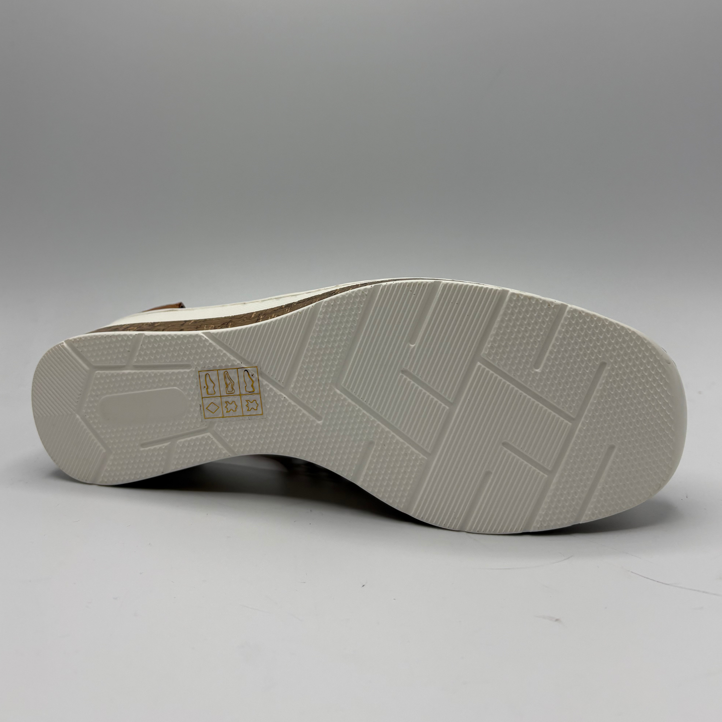 Close-up of a shoe sole with a brand logo on a gray background