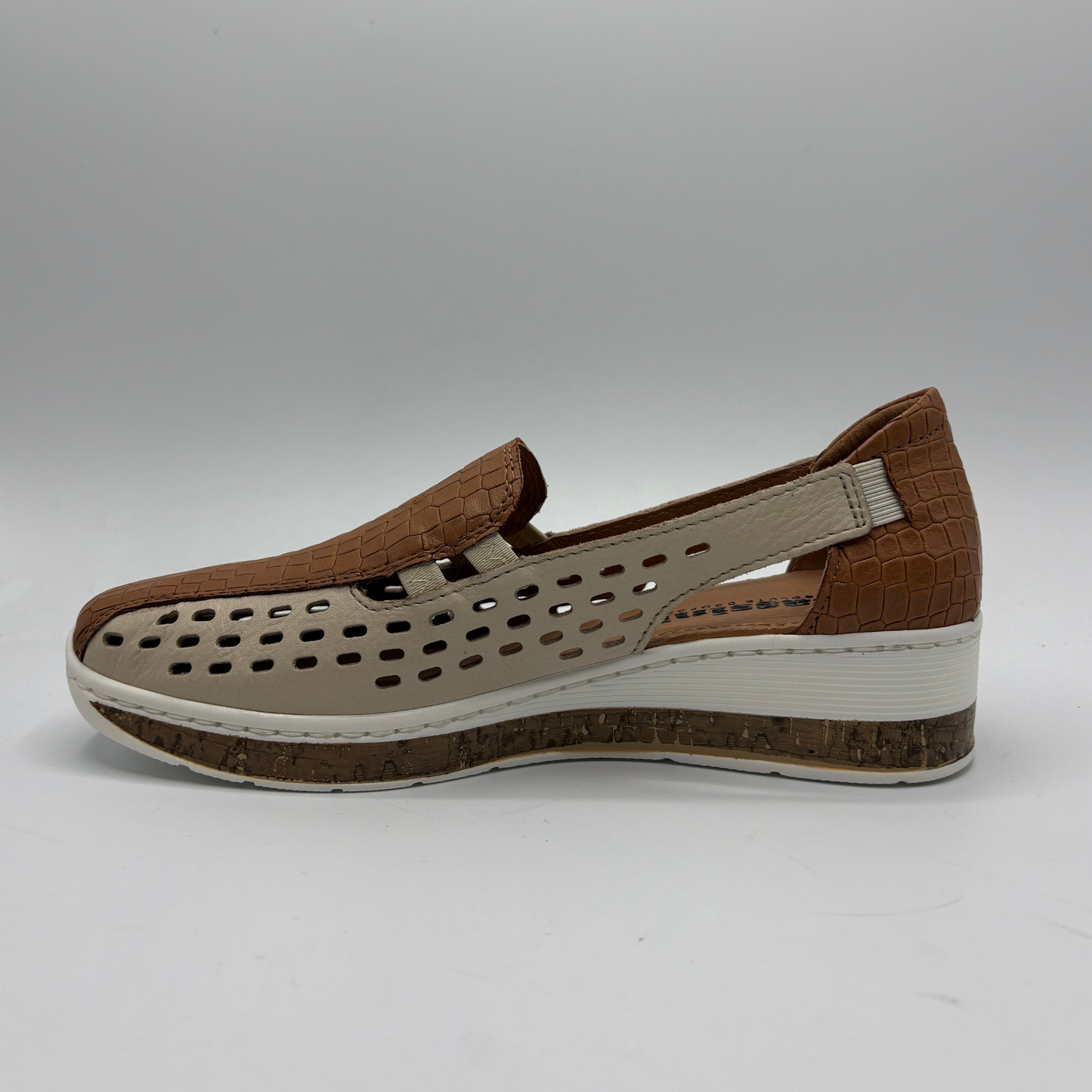 Brown and beige shoe with a white sole on a gray background