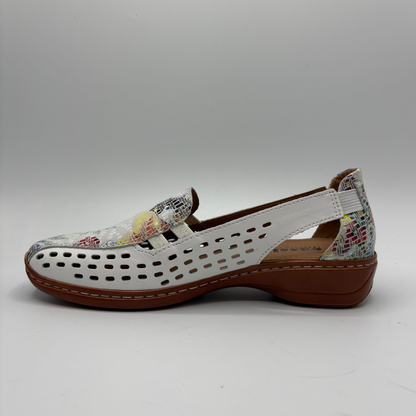White shoe with floral patterned straps on a gray background
