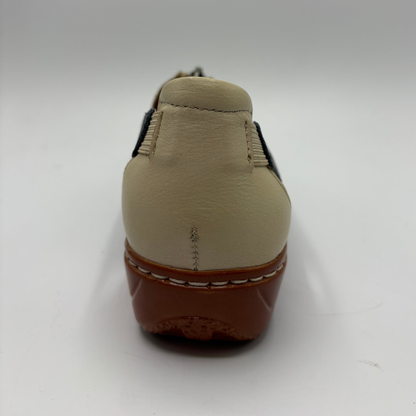 Beige shoe with brown sole on a white background