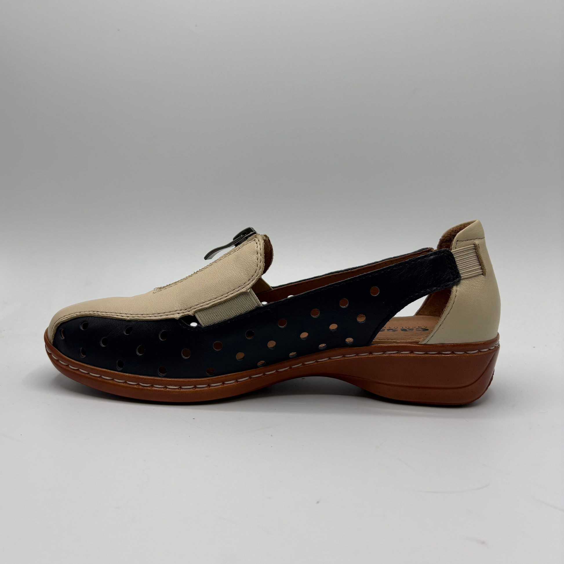 Beige and brown shoe with black sole on a white background