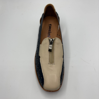 Loafer shoe with beige side panel and black sole on a white background