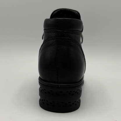 Back view of a black ankle boot with a side zipper closure and slight wedge sole