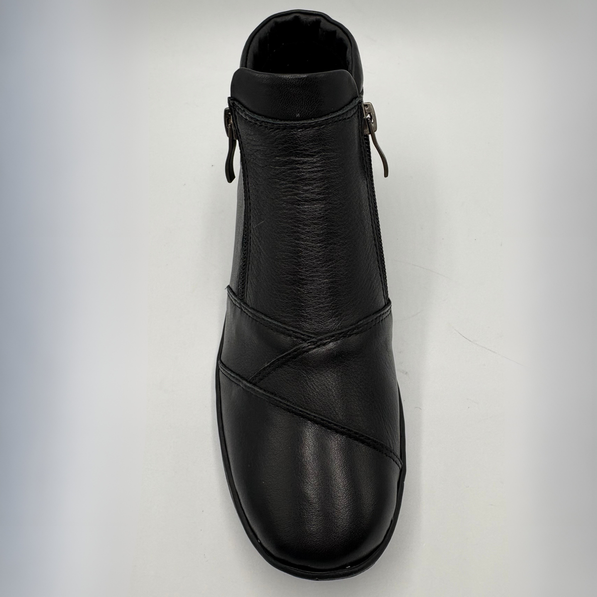 Top view of a black ankle boot with a side zipper closure and slight wedge sole