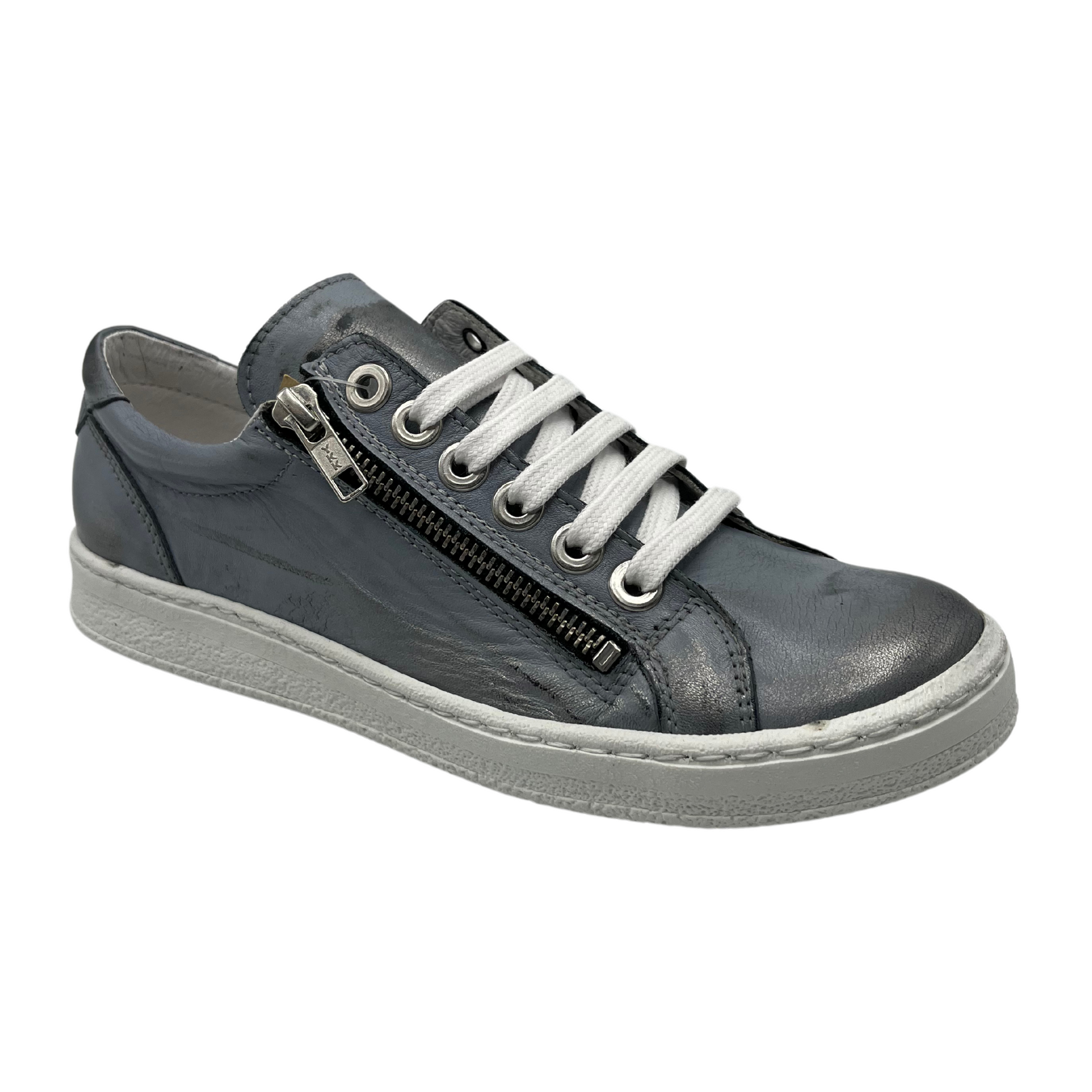 45 degree angled view of metallic silver leather sneaker with white laces and side zipper closure