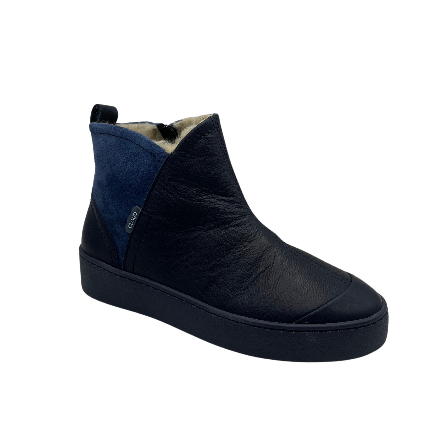 45 degree angled view of leather and suede ankle boot. Shearling lined, side zipper closure and pull on heel tab.