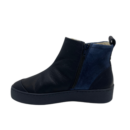 Left facing view of leather and suede ankle boot. Shearling lined, side zipper closure and pull on heel tab.