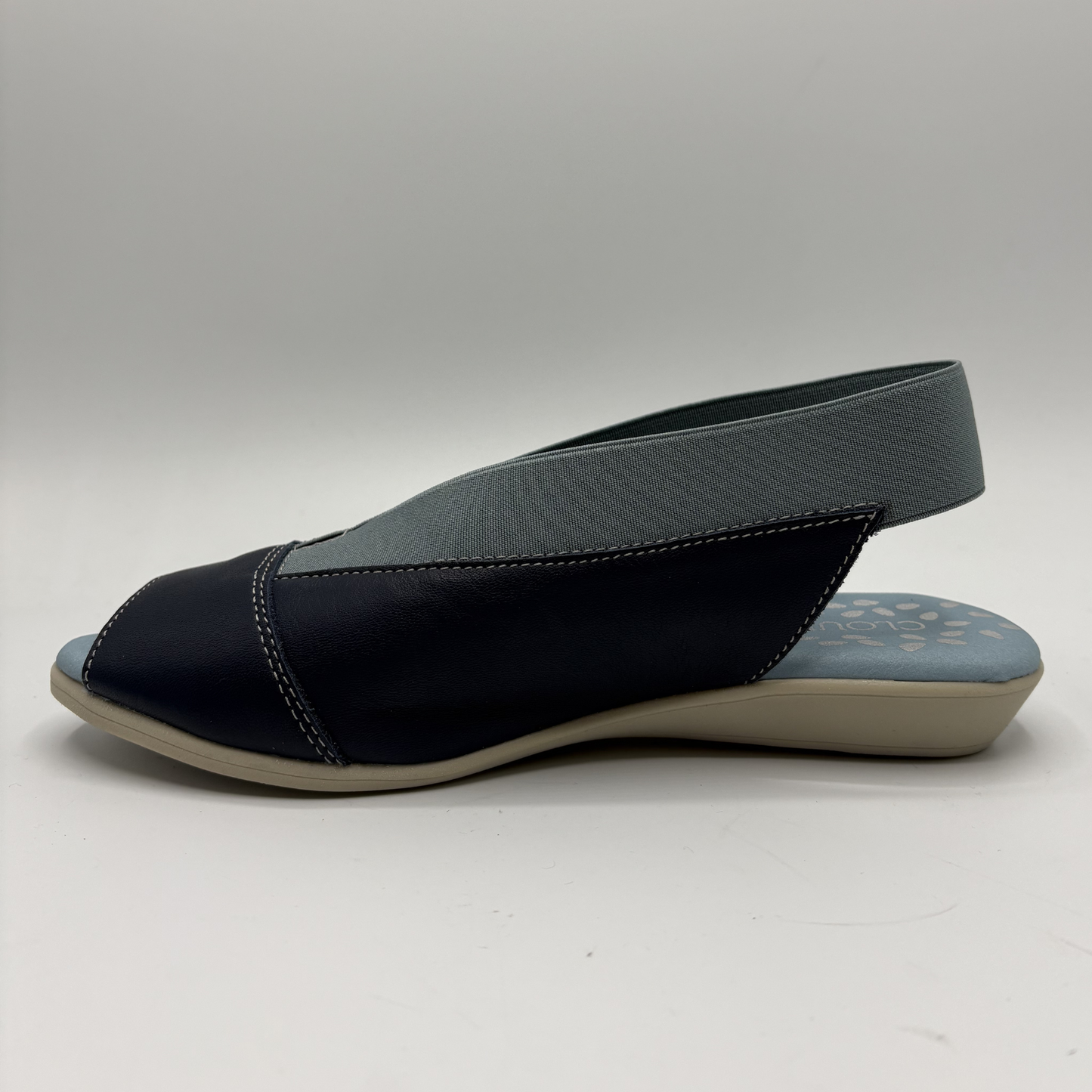 Navy sandal with a slingback design on a white background