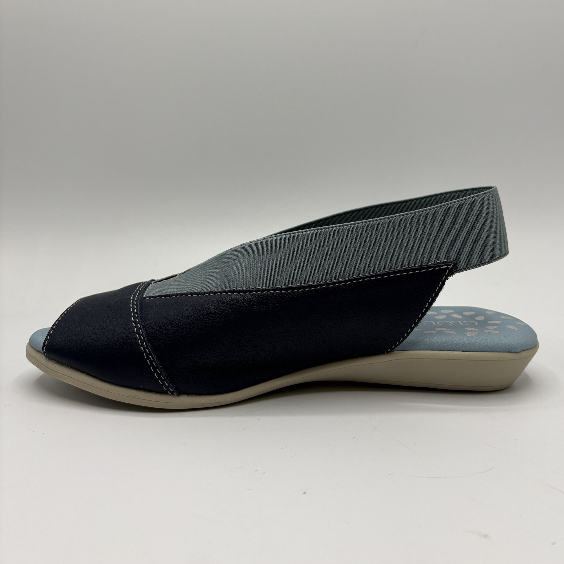 Navy sandal with a slingback design on a white background