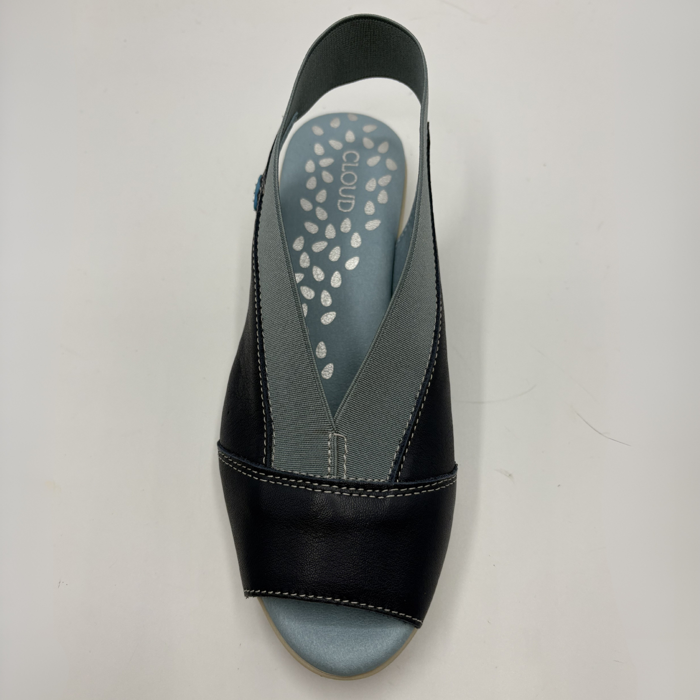 Navy sandal with a gray insole on a light gray background