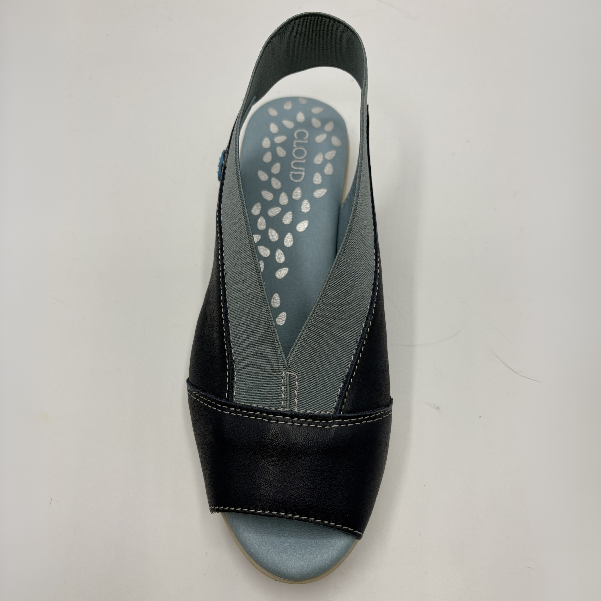 Navy sandal with a gray insole on a light gray background