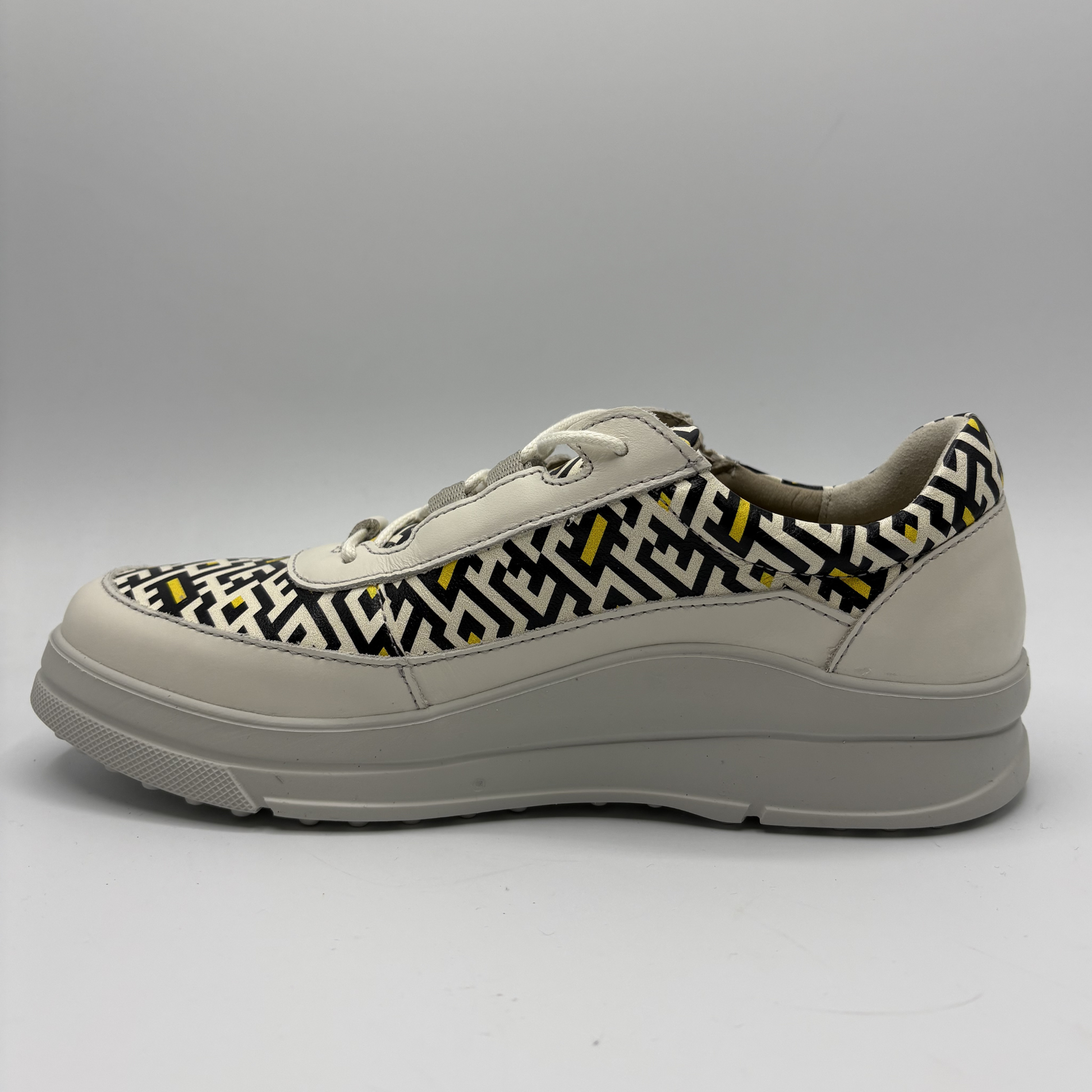 Sneaker with geometric pattern on a gray background