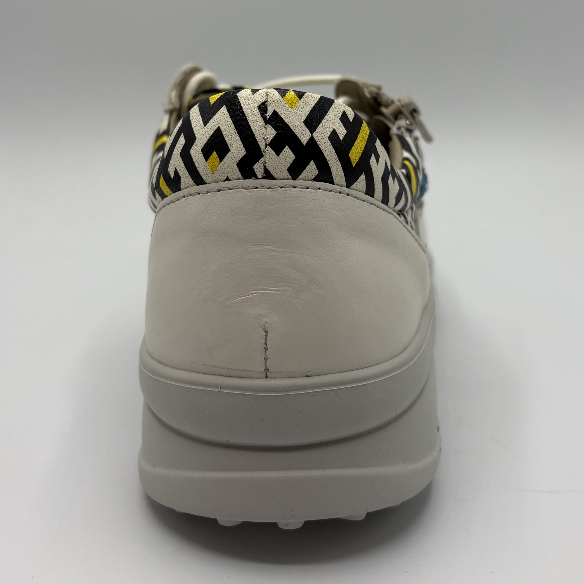 Sole of a shoe with a patterned collar on a white background