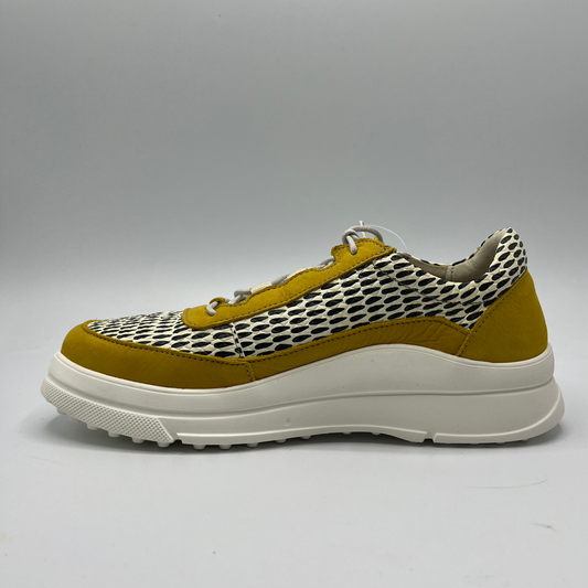 Left facing view of a mustard, black and white leather sneaker with a side zipper entry as well as functional laces. Removable insoles and 1.25 inch white rubber outsole.