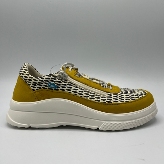 Right facing view of a mustard, black and white leather sneaker with a side zipper entry as well as functional laces. Removable insoles and 1.25 inch white rubber outsole.
