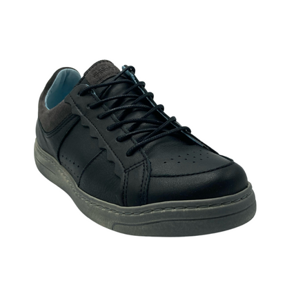 45 degree angled view of black leather sneaker with black laces and grey rubber outsole
