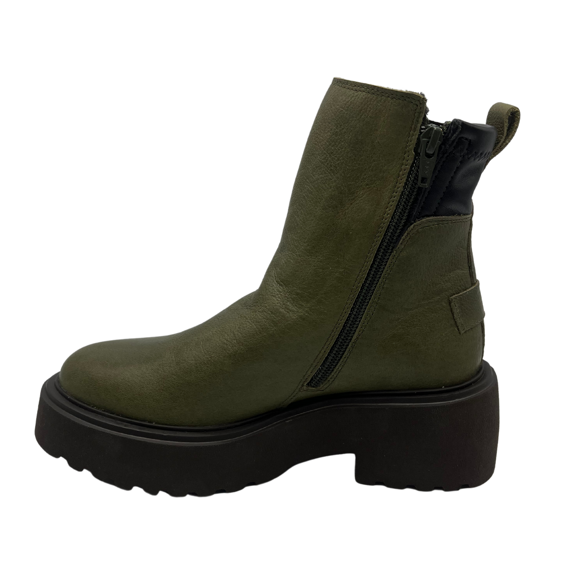 Left facing view of a khaki leather ankle boot with pull on heel tab and black lightweight lug sole