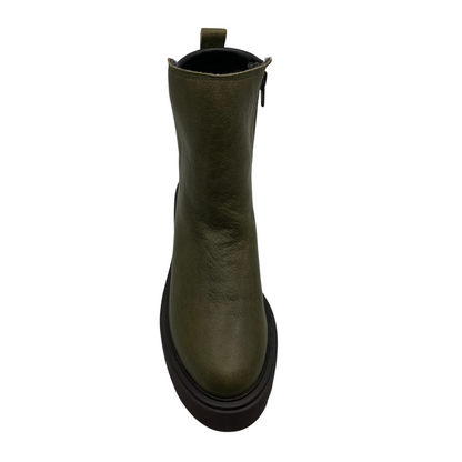 Top view of a khaki leather ankle boot with pull on heel tab and black lightweight lug sole