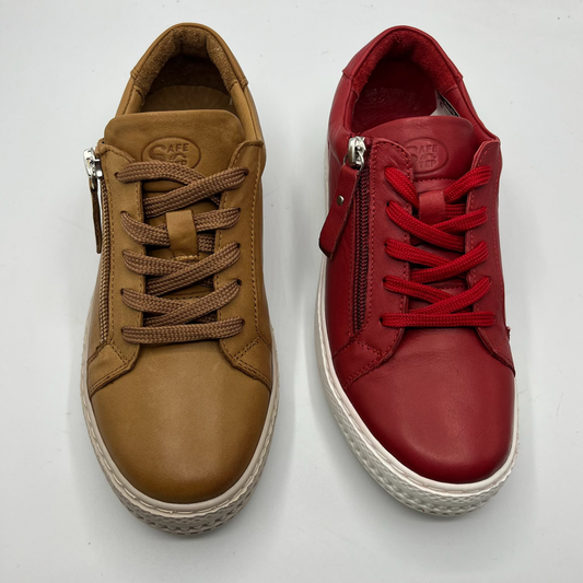 A brown sneaker beside a red sneaker. Both are leather with laces and a side zipper closure.