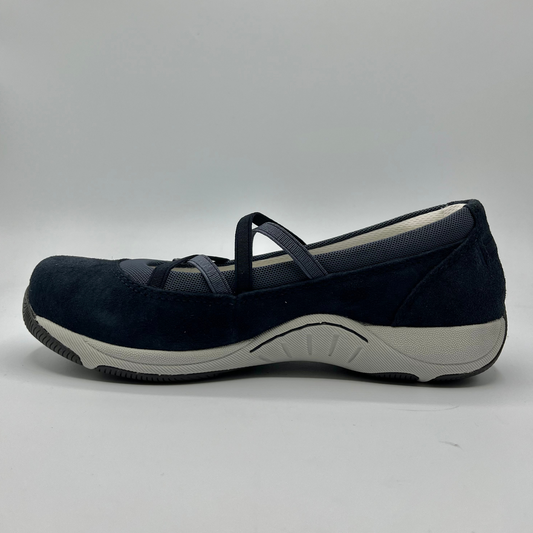 Navy blue shoe with a white sole on a gray background