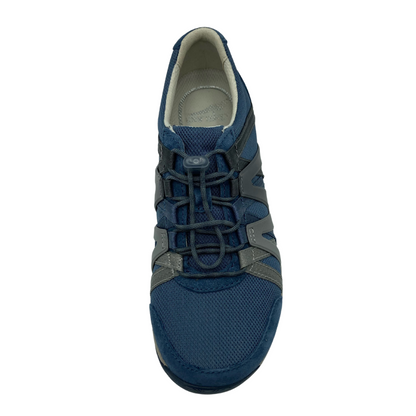 An overhead view of blue sneaker with navy cord-like laces with mesh toe and ombre zig-zag detail