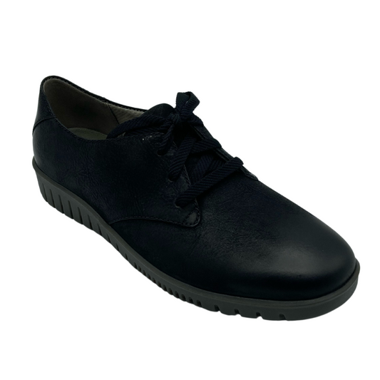 45 degree angled view of black leather oxford with black laces