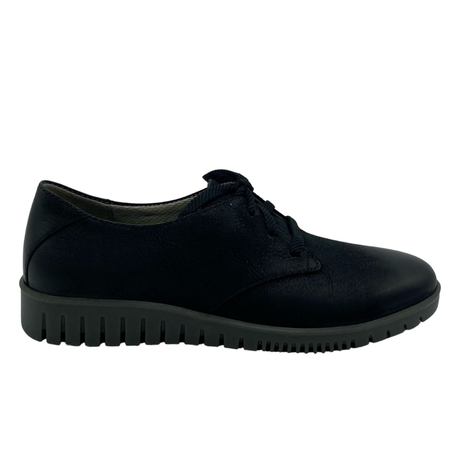 Right facing side view of black leather oxford with grey rubber soles