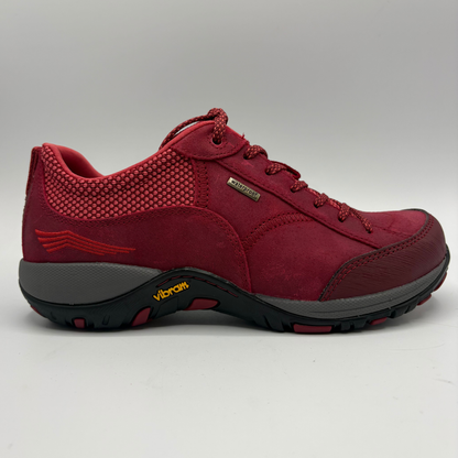 A red low top sneaker with a grey and black rubber outsole shown from the side on a white background
