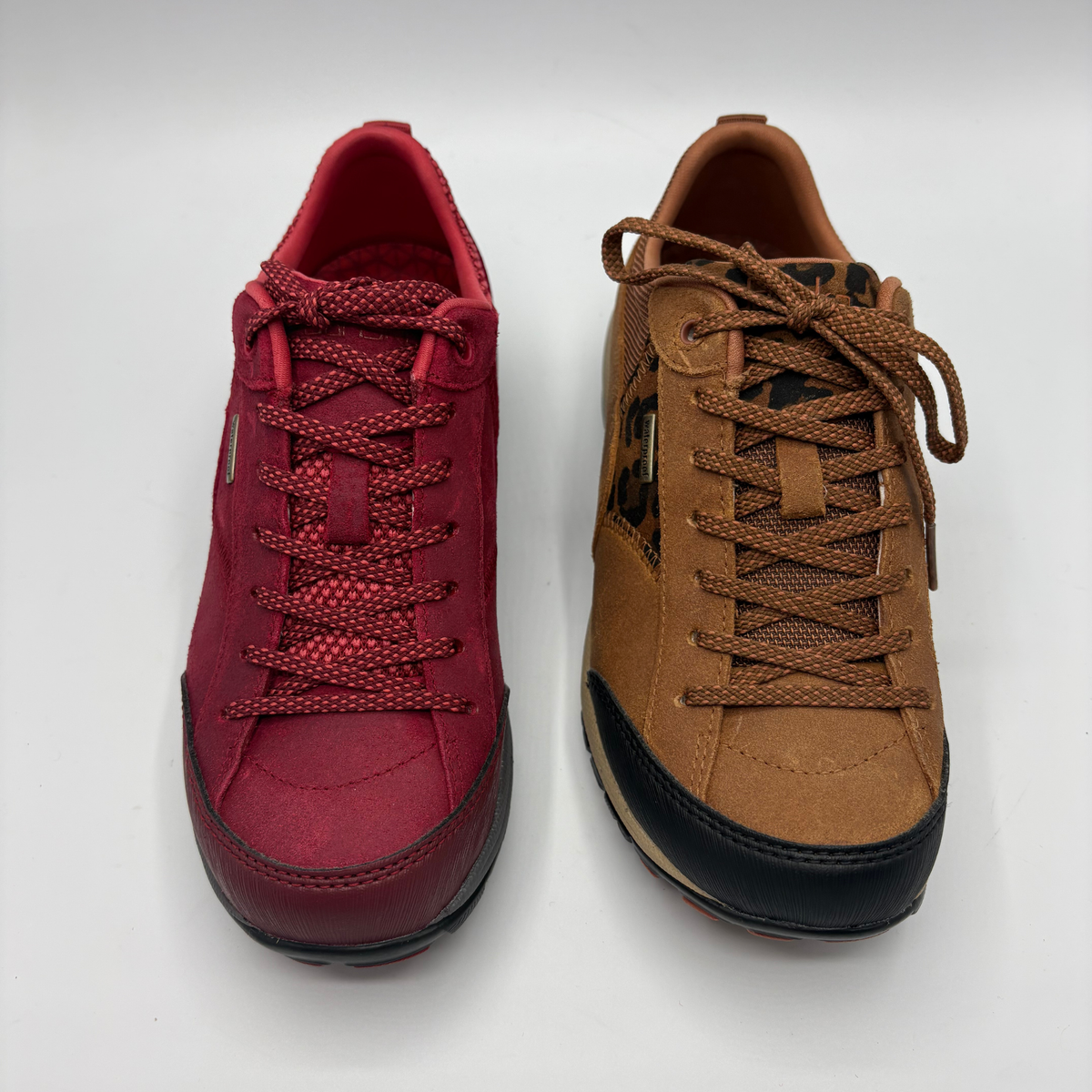 Two low top sneakers shown from above. One is red and the other is brown.