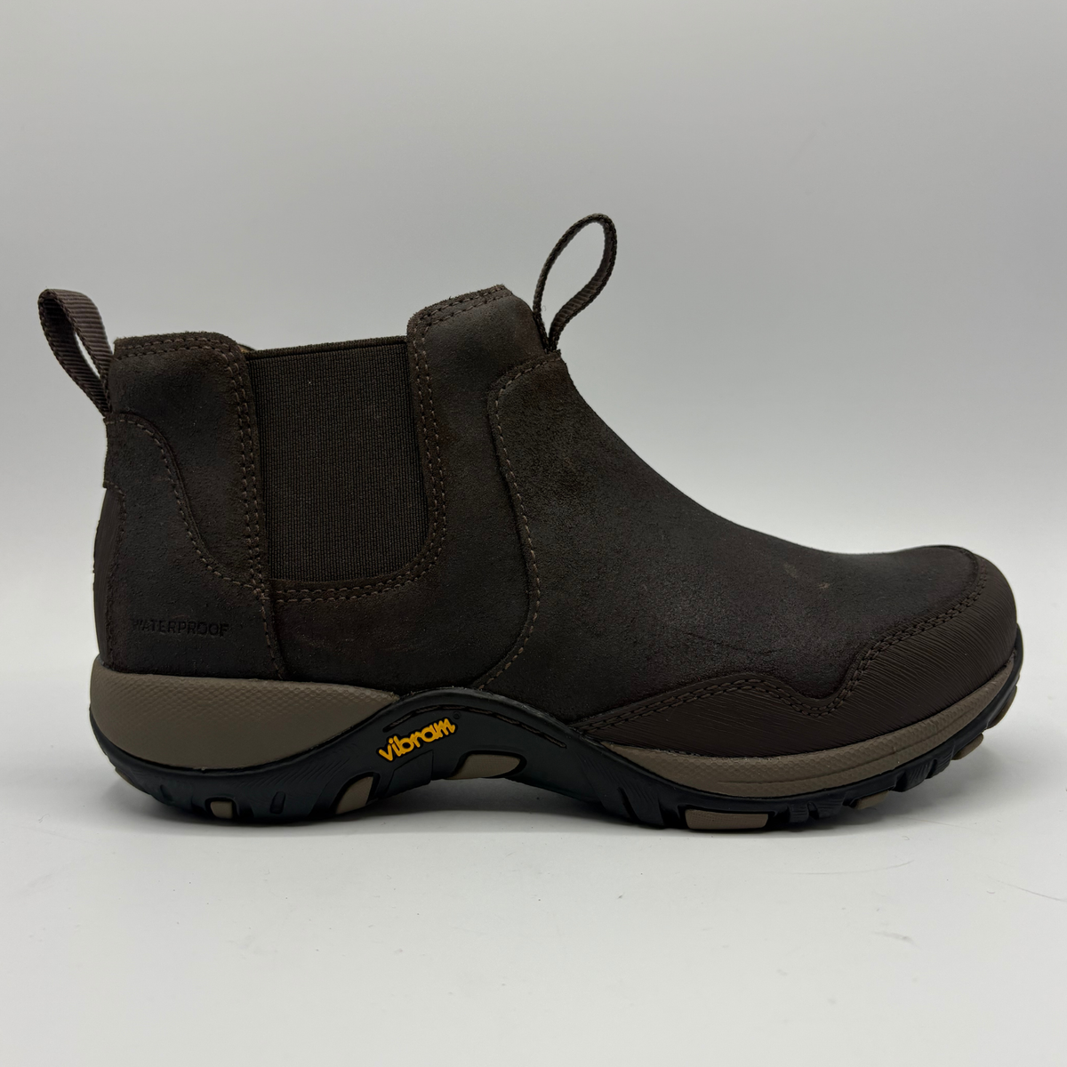 Right facing view of a short brown boot with two pull tabs and a contoured outsole
