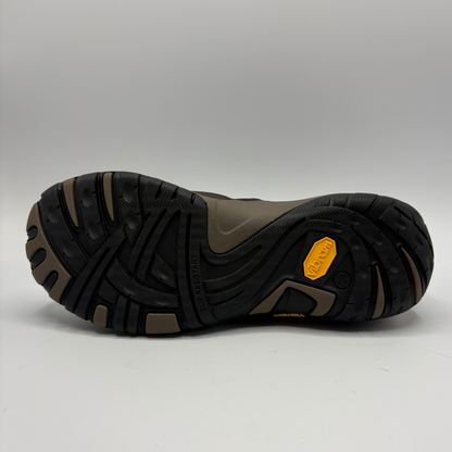 Bottom view of a short brown boot with two pull tabs and a contoured outsole