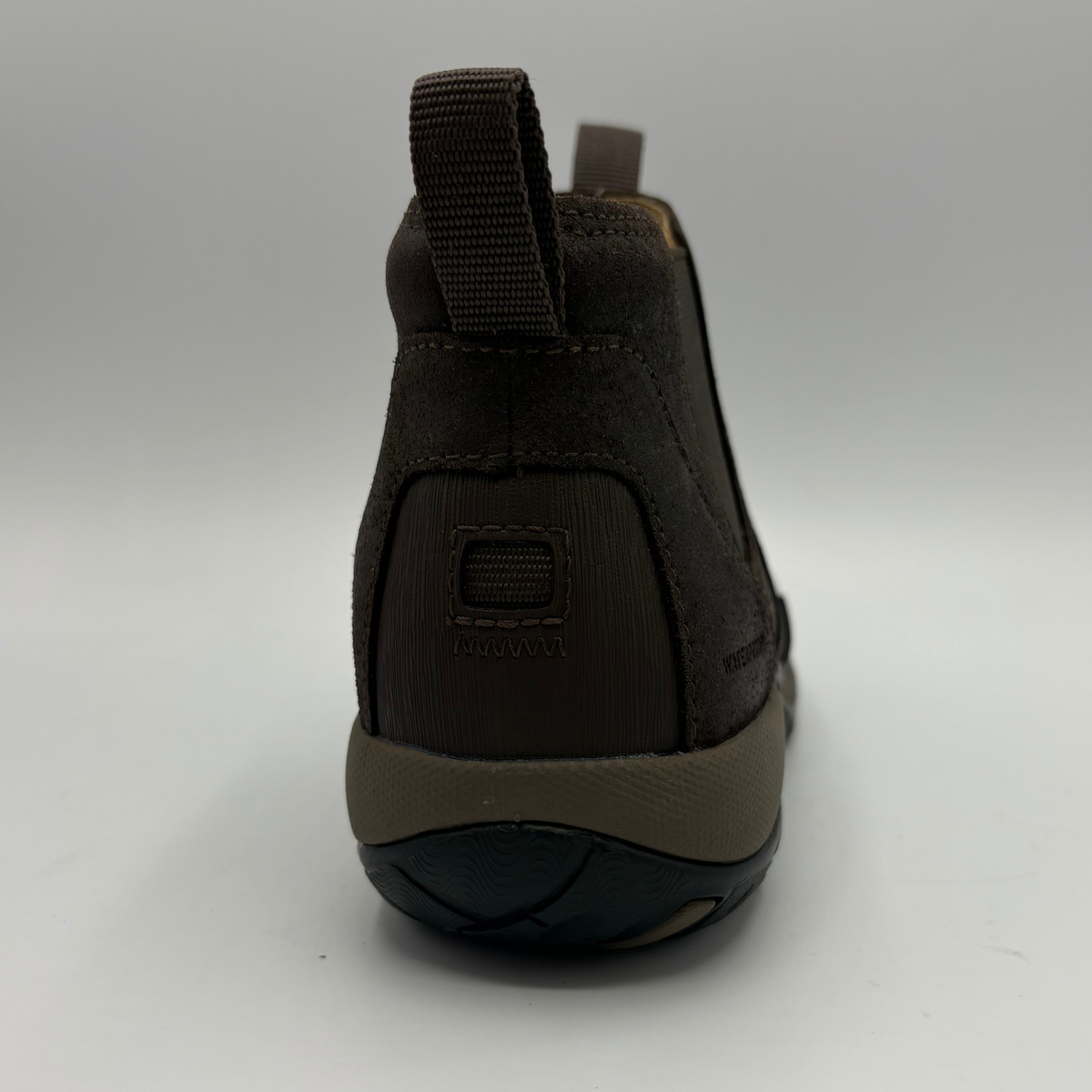 Back view of a short brown boot with two pull tabs and a contoured outsole
