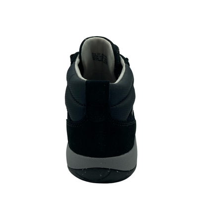 Heel view of short walking boot with dark and light grey rubber sole and black suede upper