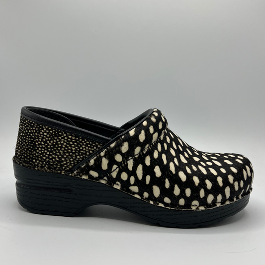 Black and white polka dot clog shoe on a gray background
