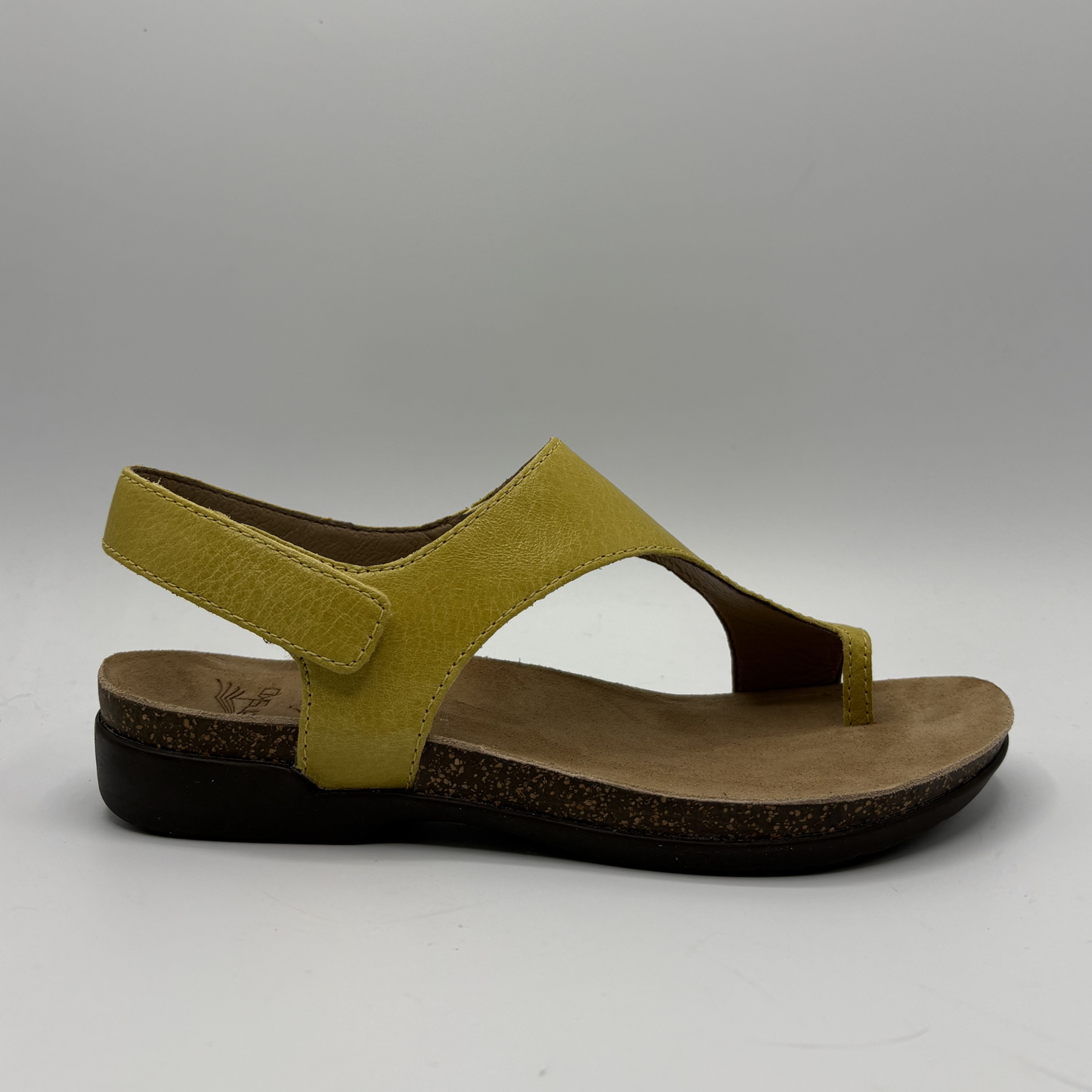 Yellow sandal with a brown sole on a gray background