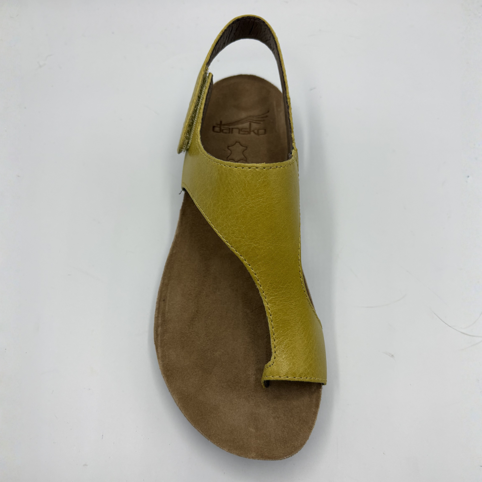 Yellow sandal with brown sole on a white background