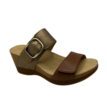 Angled view of slip on wedge sandal with adjustable straps and lined footbed.