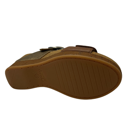 Bottom view of slip on wedge sandal with adjustable straps and suede lined footbed.