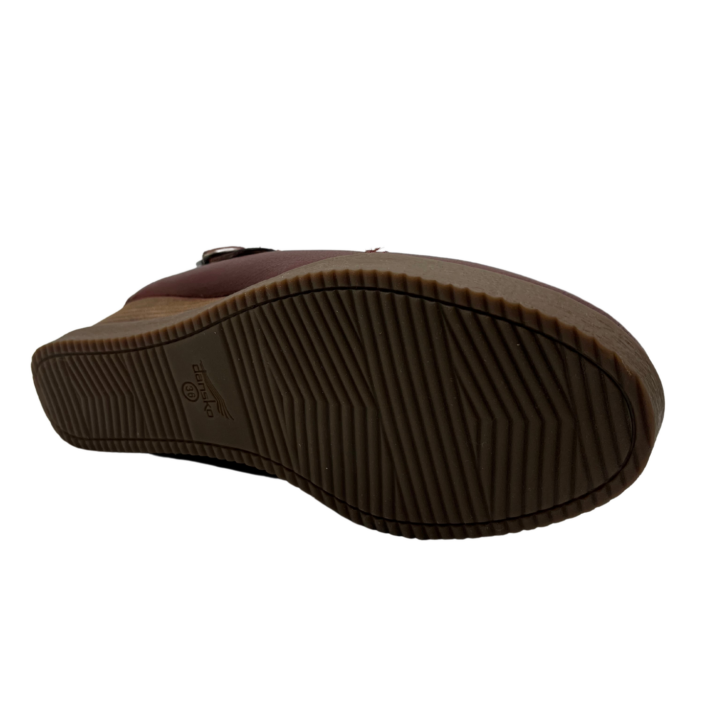 Bottom view of leather wedge slip on shoe with sling back strap and rounded toe.