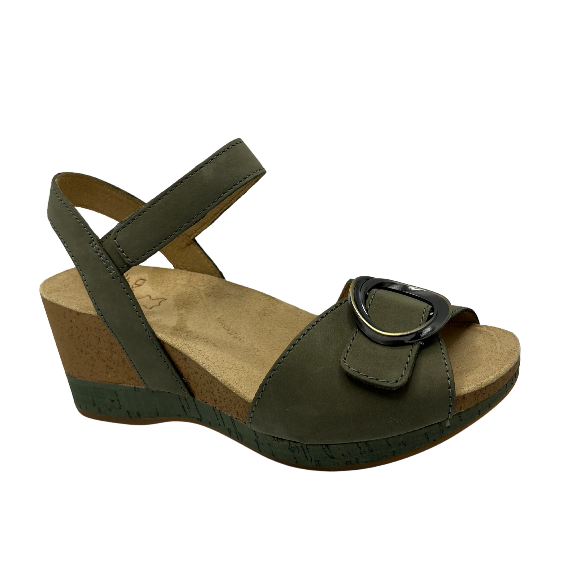 Angled view of a nubuck and suede wedge sandal with adjustable velcro straps in a soft sage colour.