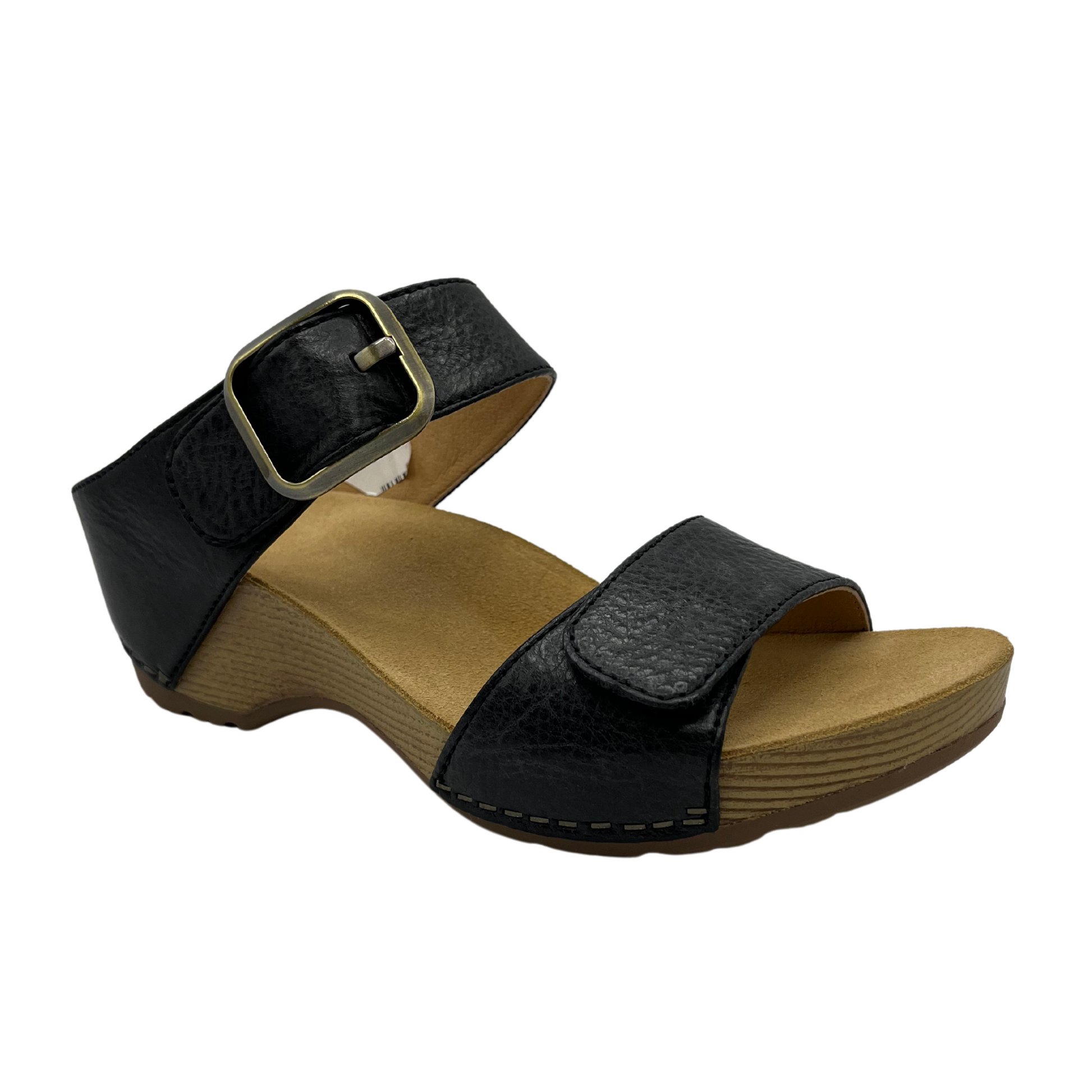 45 degree angled view of black leather strapped sandal in a slip on style with a buckle strap and tan lining